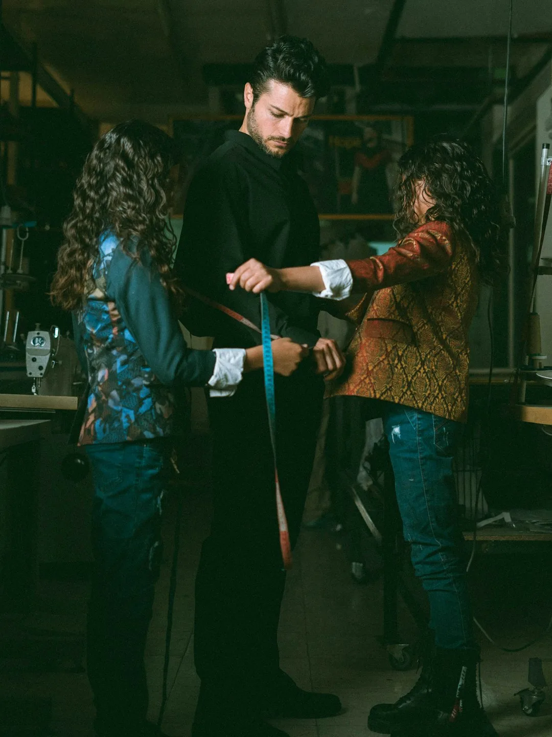 Tailor measuring customer in workshop