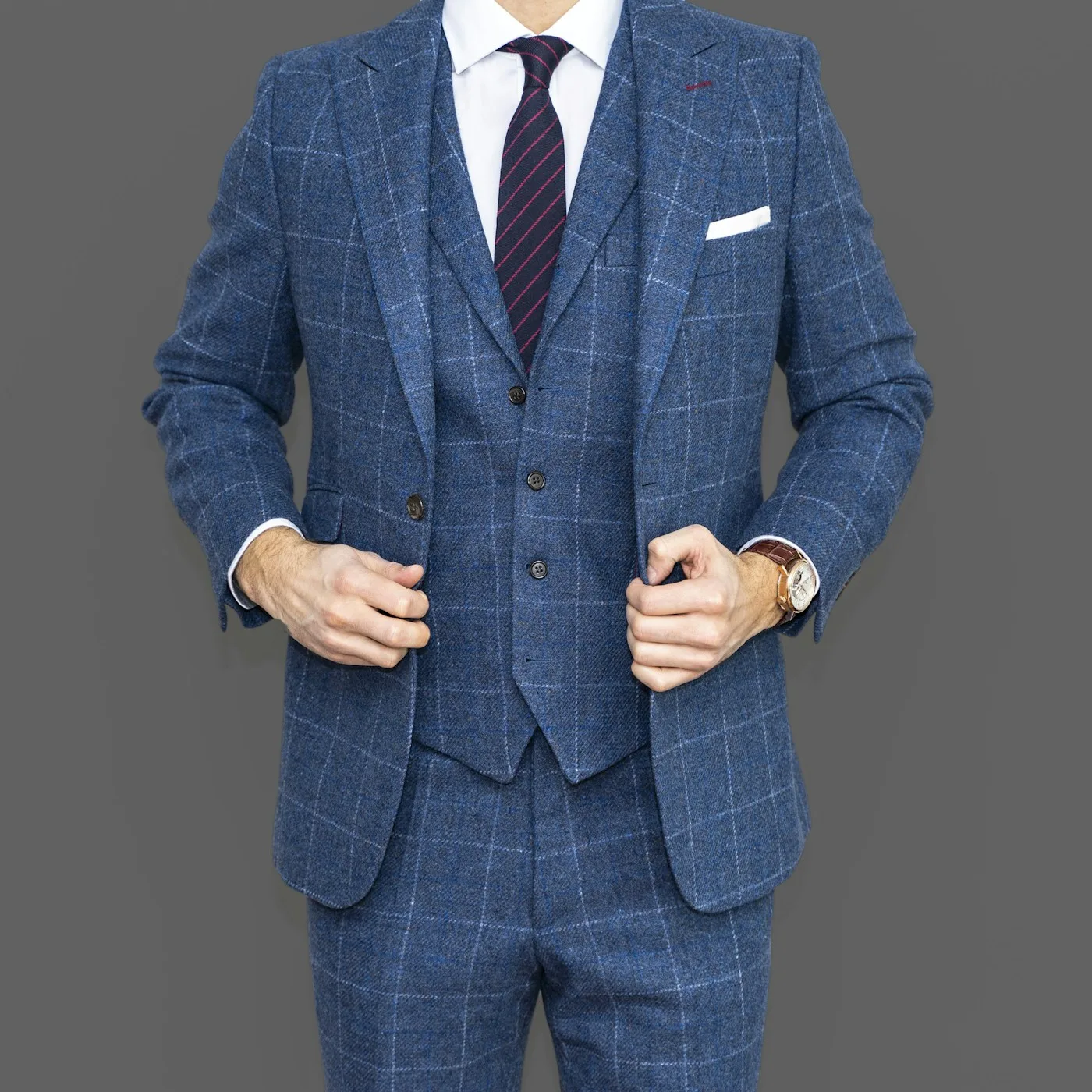 Tailored suit jacket being prepared in a refined atelier