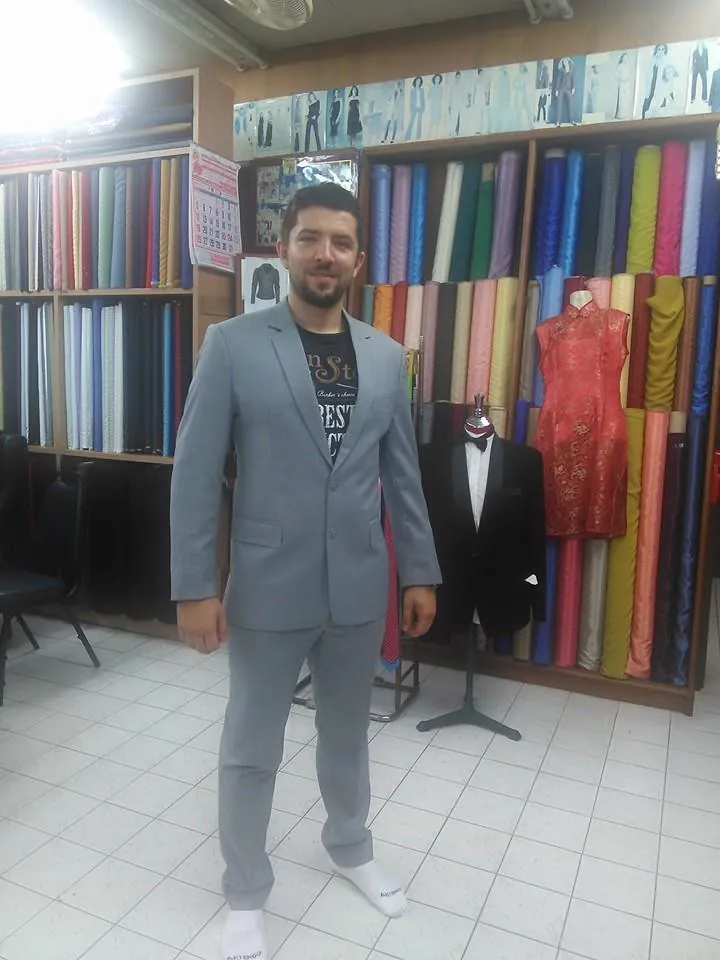 Tailor preparing formalwear fabric for a consultation